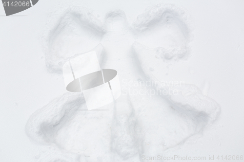 Image of angel silhouette or print on snow surface