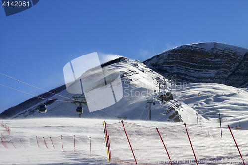 Image of Gondola lift on ski resort at windy winter day