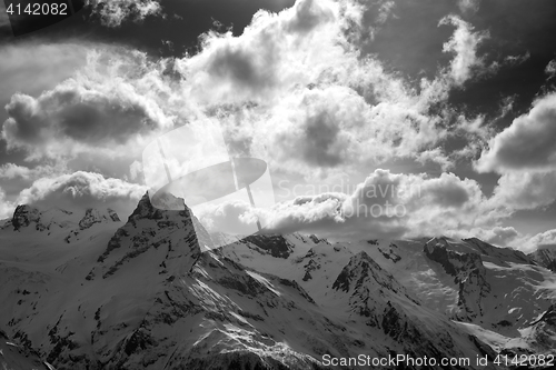 Image of Black and white snow mountains in clouds