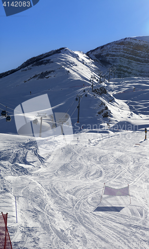 Image of Ski slope and gondola lift at sun winter evening