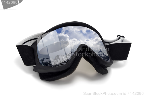 Image of Ski goggles with reflection of winter snow mountains