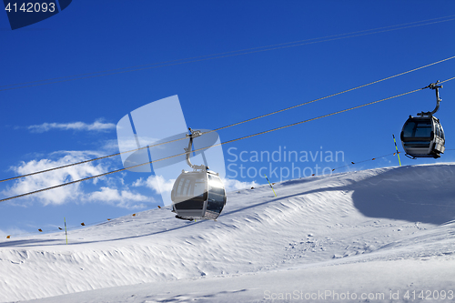 Image of Gondola lifts on ski resort at sun wind day