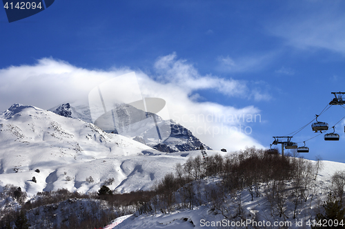 Image of Ski-lift, off-piste slope and mountain in clouds