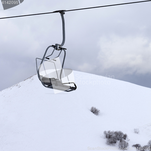 Image of Chair lift and gray sky at evening