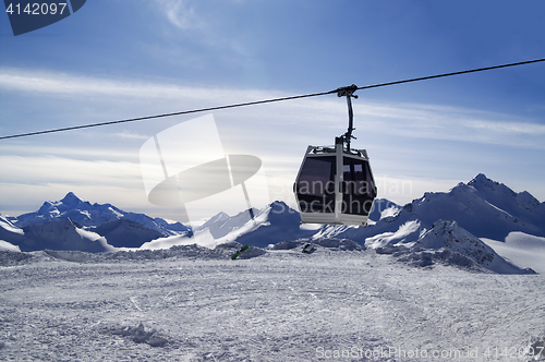 Image of Ski lift in snow winter mountains at evening