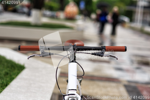 Image of white fixed-gear bicycle on street