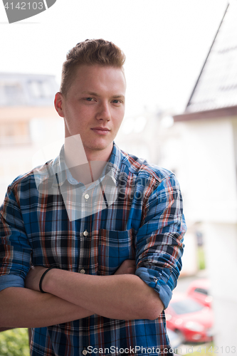 Image of man standing at balcony