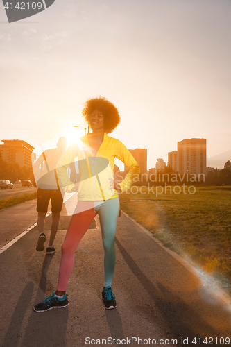 Image of Portrait of sporty young african american woman running outdoors