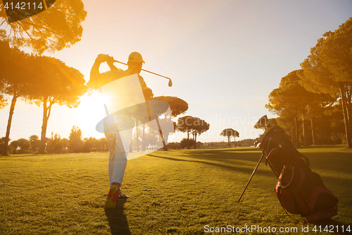 Image of golf player hitting shot with club