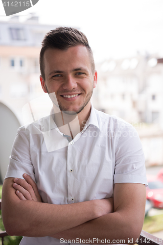 Image of man standing at balcony