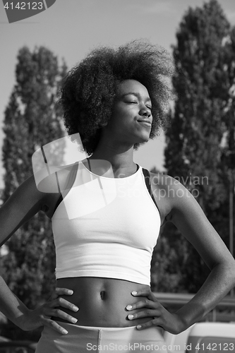 Image of Portrait of sporty young african american woman running outdoors