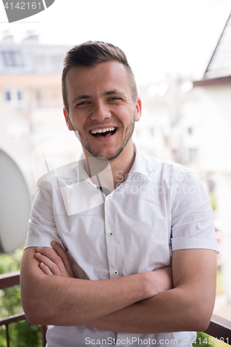 Image of man standing at balcony