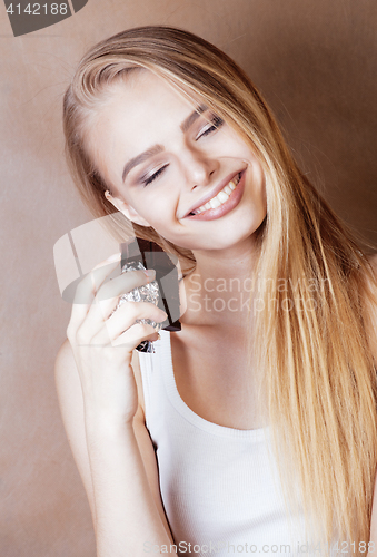 Image of young beauty blond teenage girl eating chocolate smiling