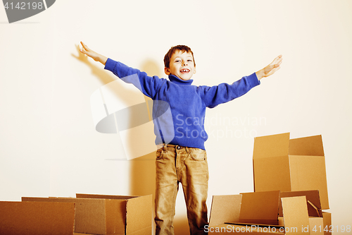 Image of little cute boy in empty room, remoove to new house. home alone, lifestyle people concept