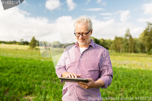 Image of senior man with tablet pc computer at county