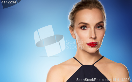 Image of beautiful woman in black over blue background