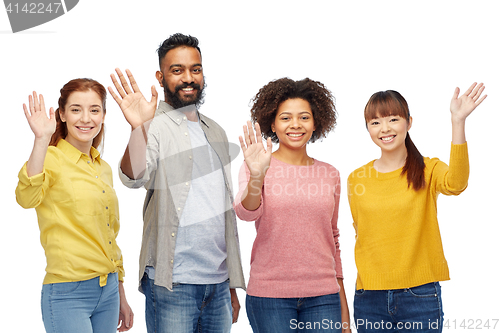 Image of international group of happy people waving hands