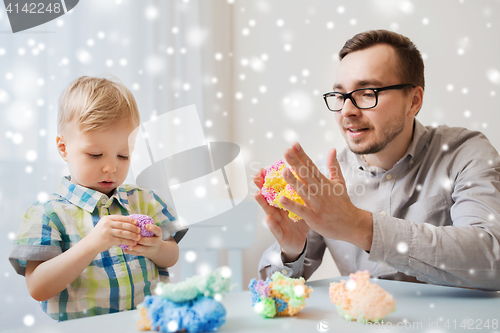 Image of father and son playing with ball clay at home