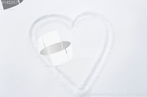 Image of heart shape silhouette or print on snow surface