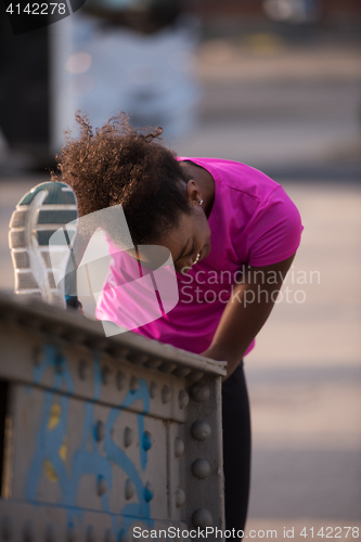 Image of African American woman doing warming up and stretching