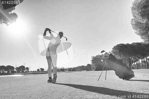 Image of golf player hitting shot with club