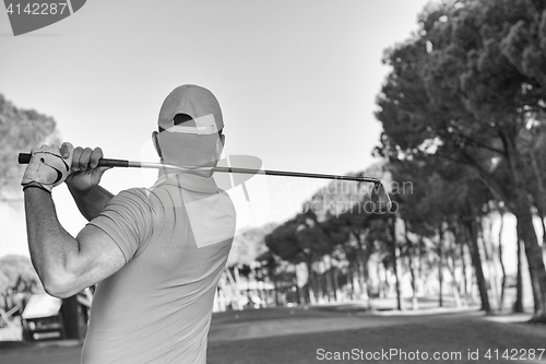 Image of golf player hitting shot with club