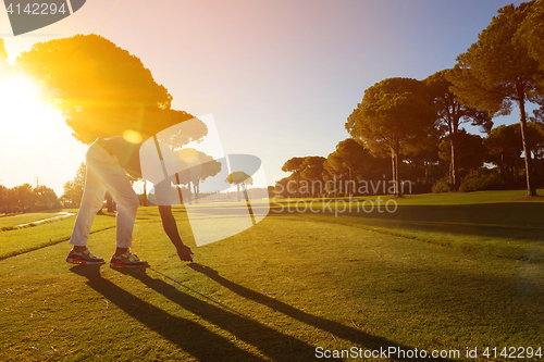 Image of golf player hitting shot with club