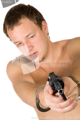 Image of The young man with a pistol. Focus on pistol. Isolated
