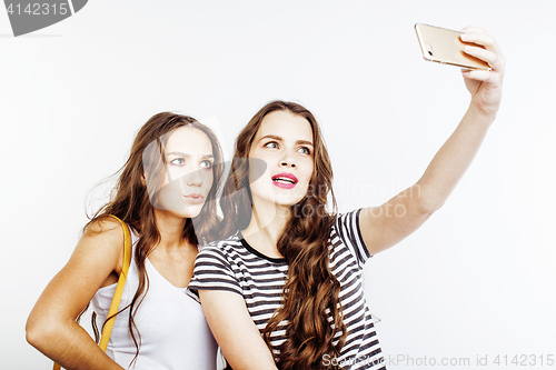 Image of two best friends teenage girls together having fun, posing emotional on white background, besties happy smiling, making selfie, lifestyle people concept