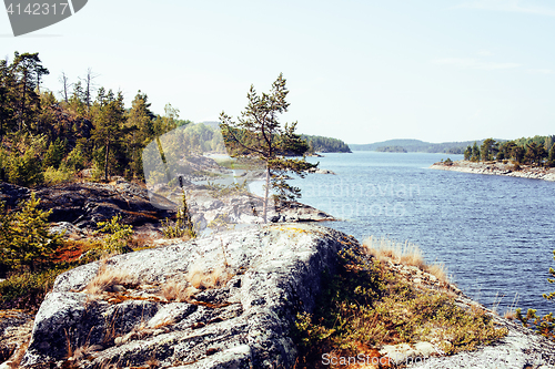 Image of wild north nature landscape. lot of rocks on lake shore