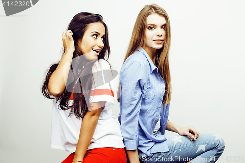 Image of best friends teenage girls together having fun, posing emotional on white background, besties happy smiling, lifestyle people concept, blond and brunette multi nations