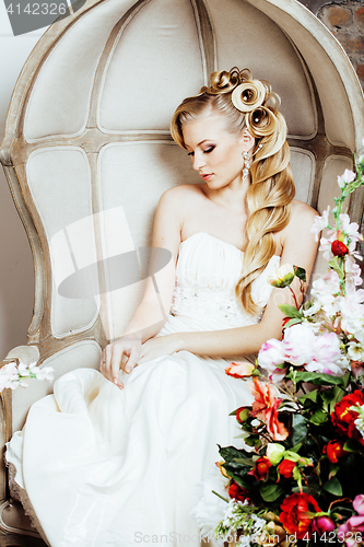 Image of beauty young bride alone in luxury vintage interior with a lot of flowers close up