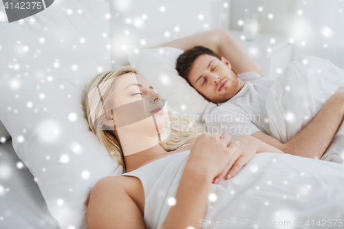 Image of happy couple sleeping in bed at home