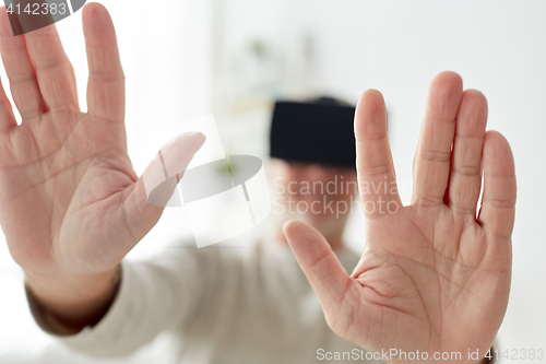 Image of old man in virtual reality headset or 3d glasses