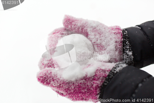 Image of close up of woman holding snowball outdoors