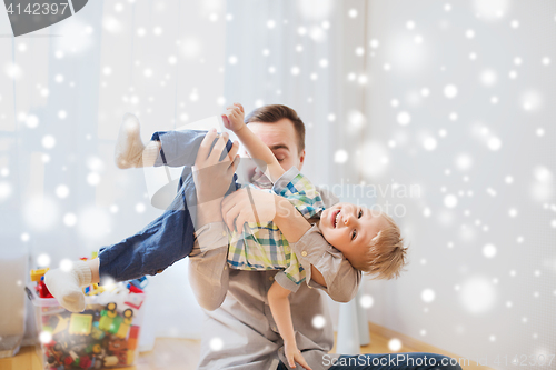 Image of father with son playing and having fun at home