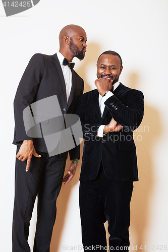 Image of two afro-american businessmen in black suits emotional posing, g