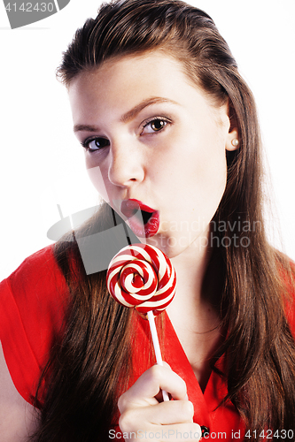 Image of young pretty brunette girl with red candy posing on white backgr