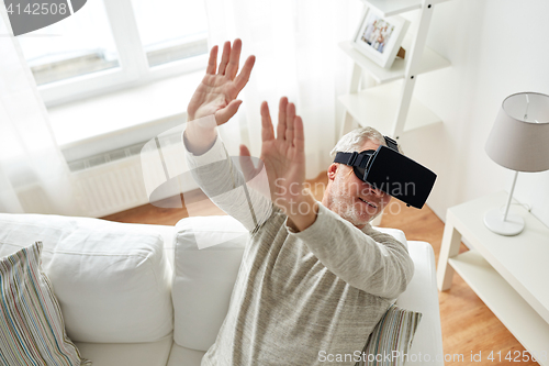 Image of old man in virtual reality headset or 3d glasses