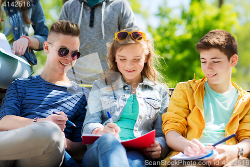 Image of group of students with notebooks at school yard