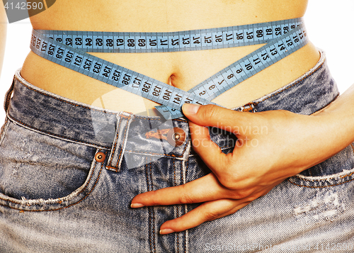 Image of girls stomach measuring with tape twice isolated
