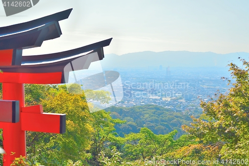 Image of Kyoto cityscape from Inariyama mountain with a red torii gate.