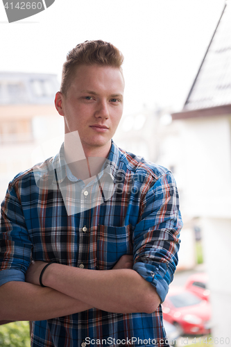 Image of man standing at balcony