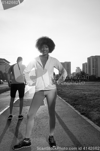 Image of Portrait of sporty young african american woman running outdoors