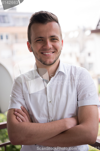 Image of man standing at balcony