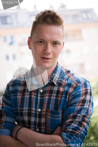 Image of man standing at balcony