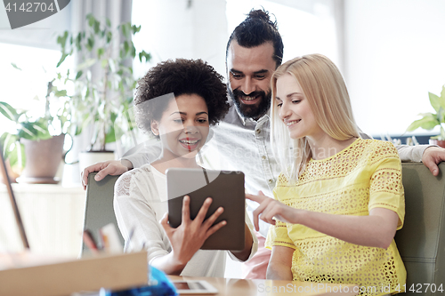 Image of happy creative team with tablet pc in office