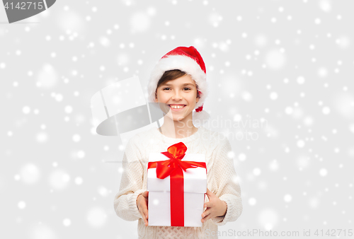 Image of smiling happy boy in santa hat with gift box