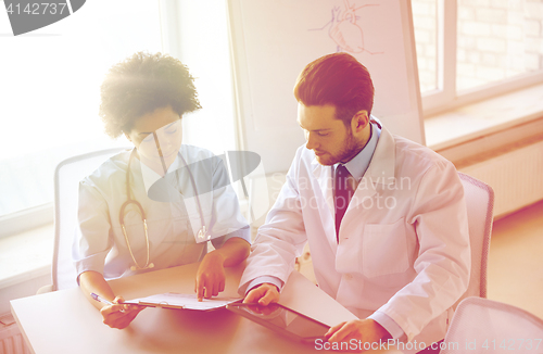 Image of doctors with tablet pc and clipboard at hospital