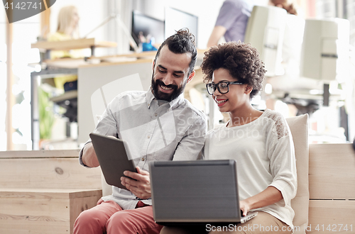 Image of creative team with laptop and tablet pc in office